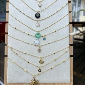 Gold Layered Sun & Charm Necklace Set with Green and Black Accents